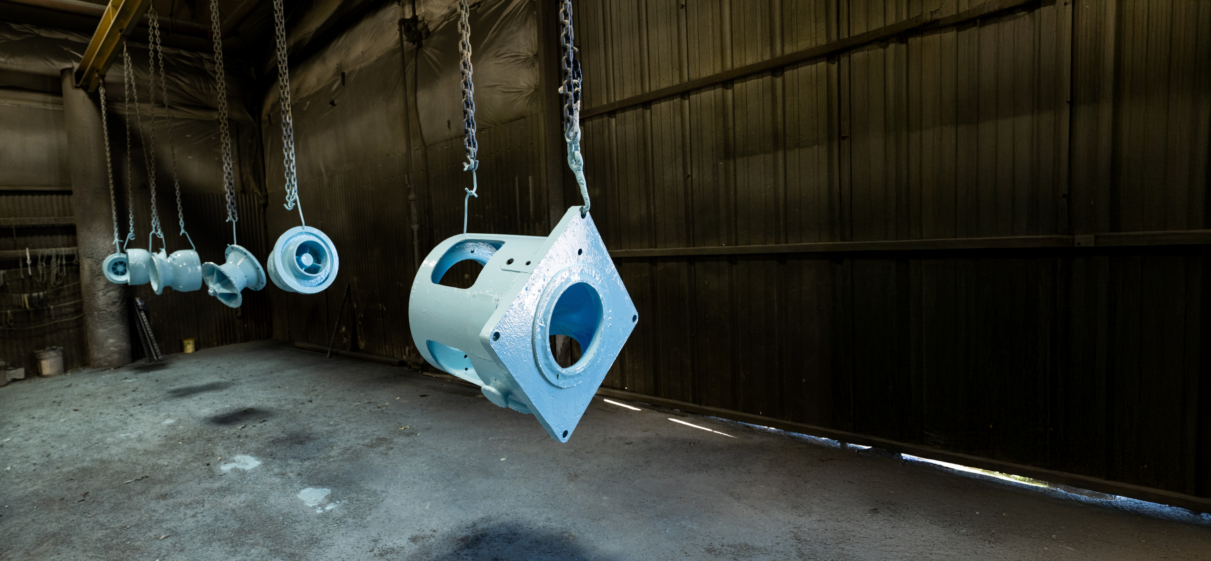 Industrial coating facility with hanging metal parts